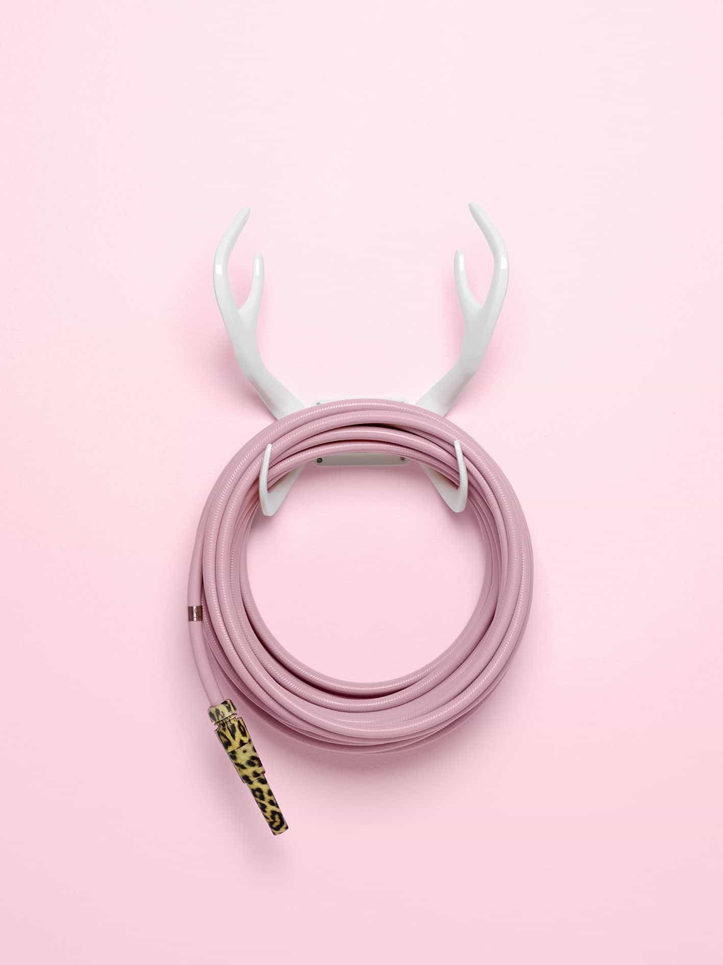 Garden Glory - Stylish garden equipment - pink garden hose with leopard print nozzle wall-mounted on white antlers