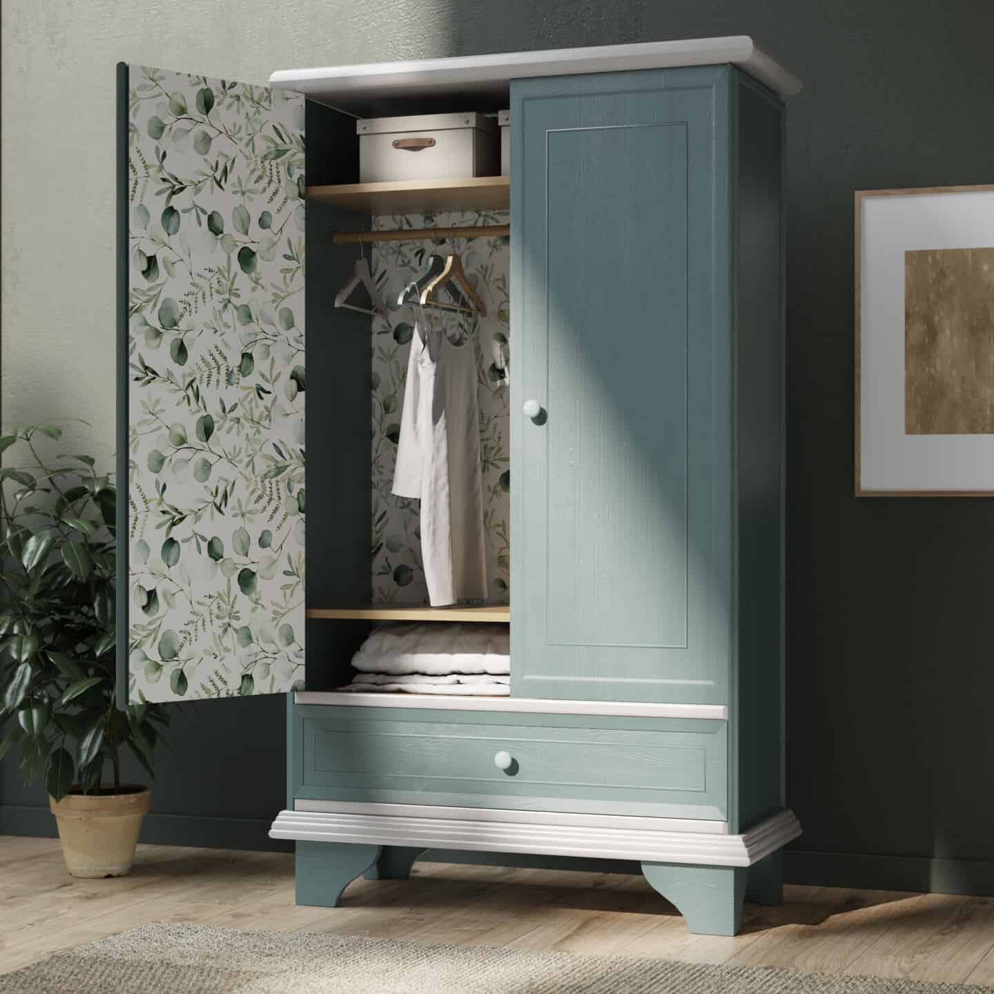 An upcycled wooden wardrobe that has been repainted green and been lined with botanical wallpaper