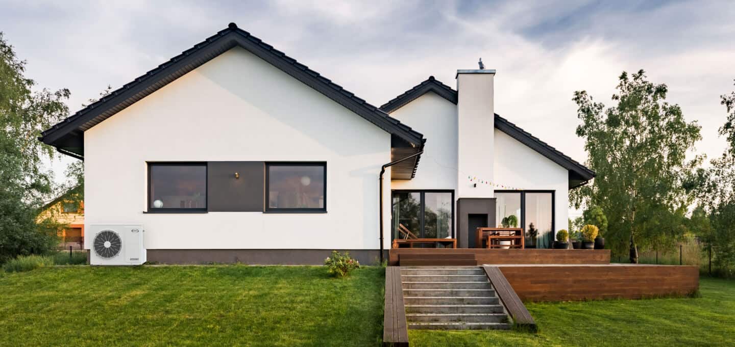 A house with a heat pump installed outside for heating