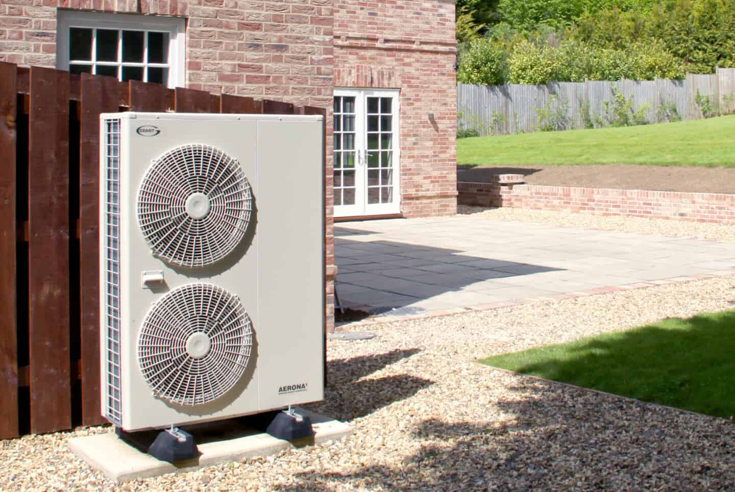 Close up of a heat pump outside a house