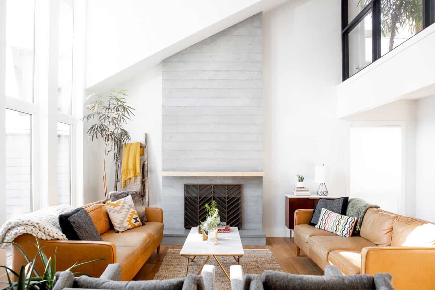 Boho style living room in a luxury home with large floor to ceiling windows