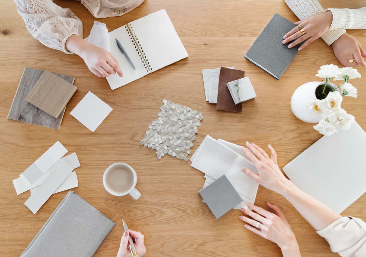 4 women sit around a table planning an interior design project