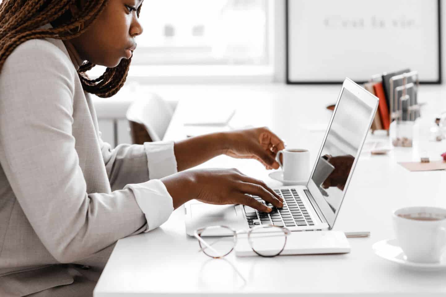 A young woman sat at a desk on a laptop