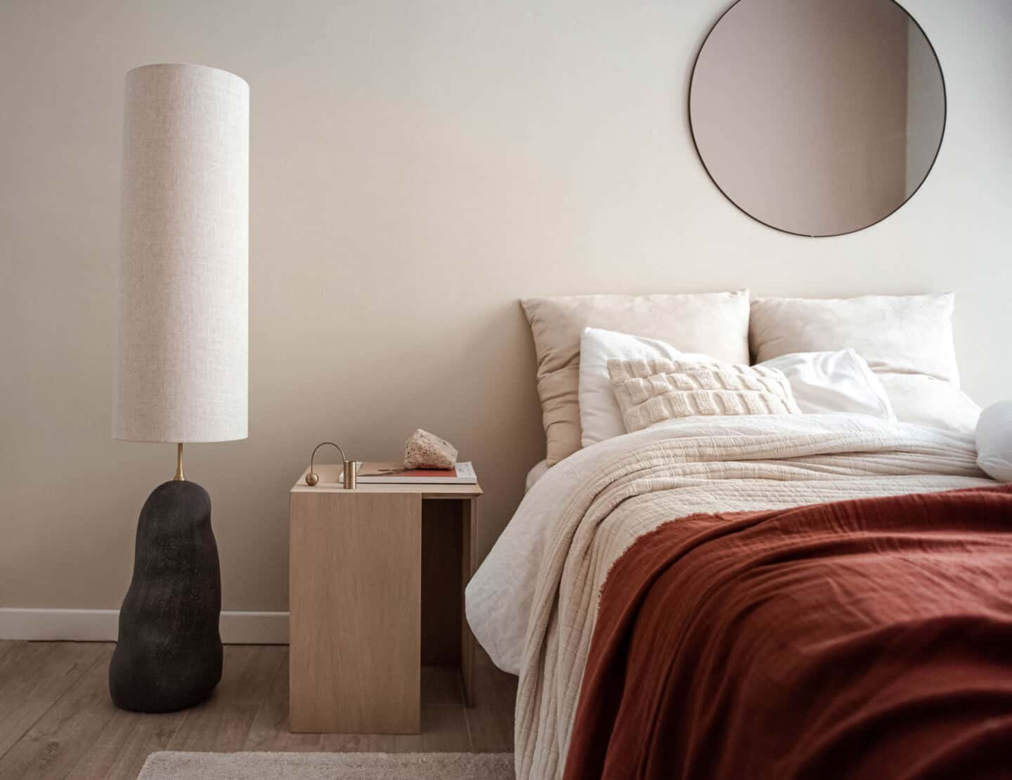 A bedroom featuring natural bedding in earthy colours