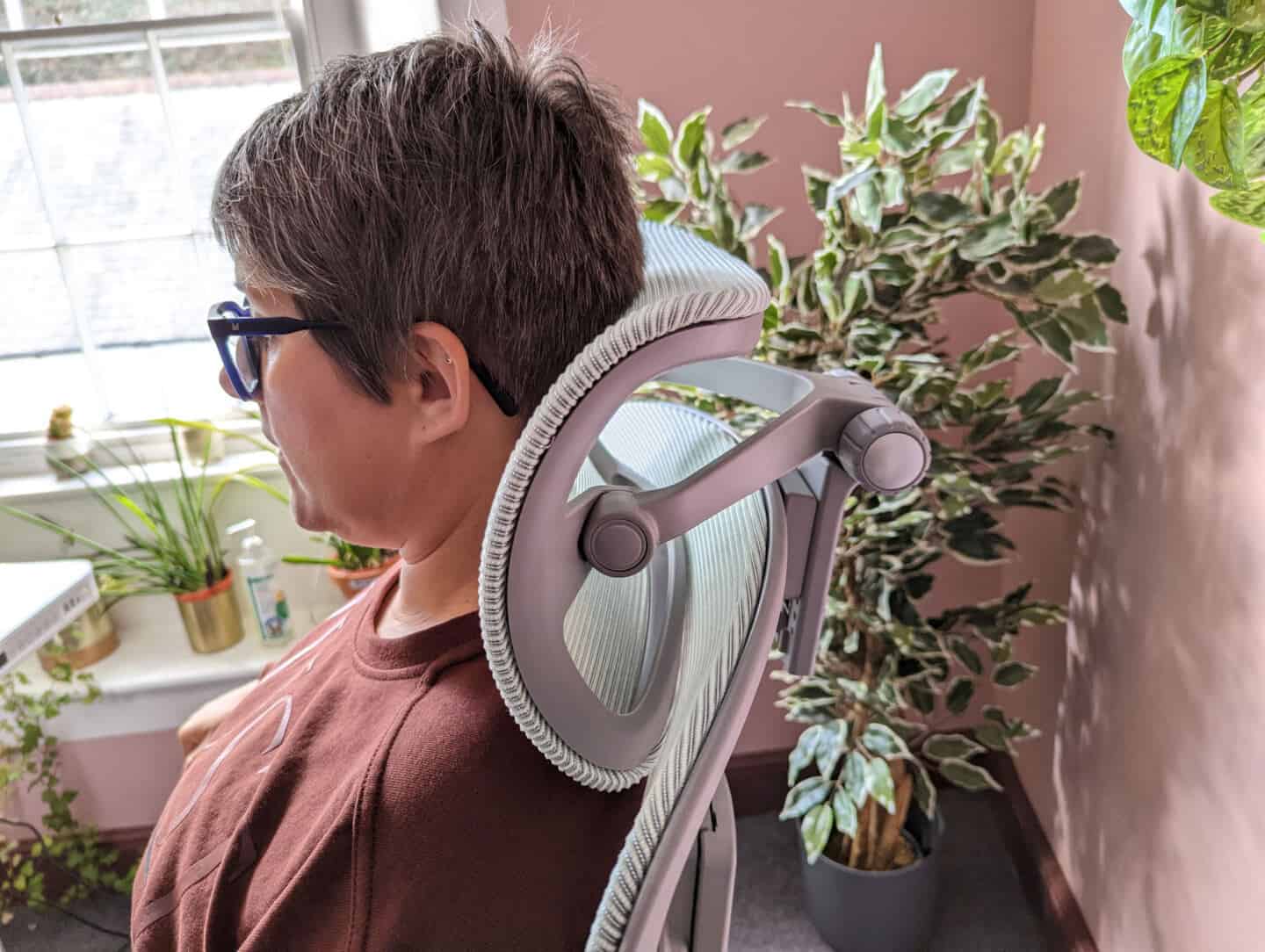 A woman's head against the headrest of an Ergonomic Office Chair