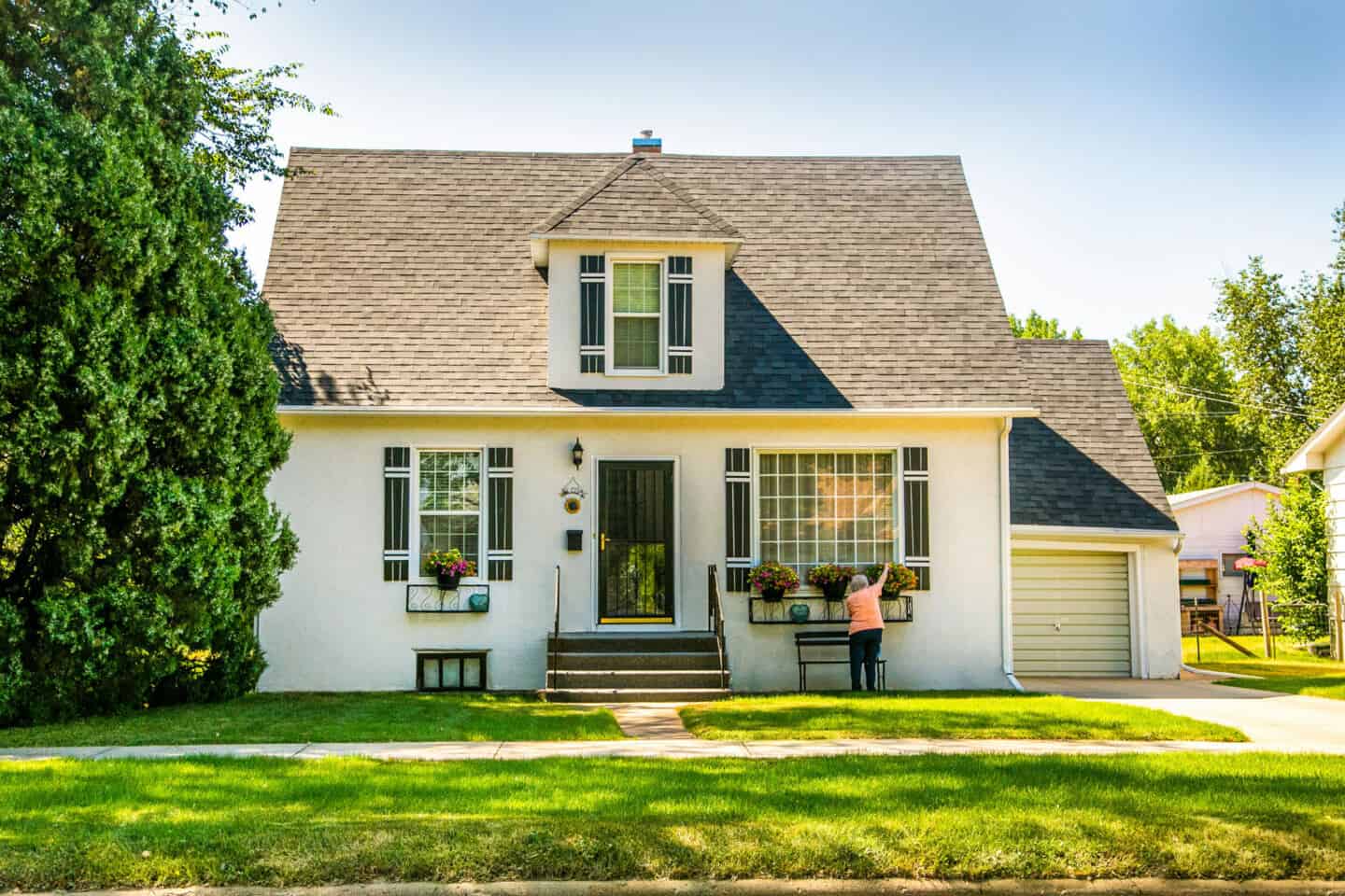 A beautiful white detached home with connecting garage.