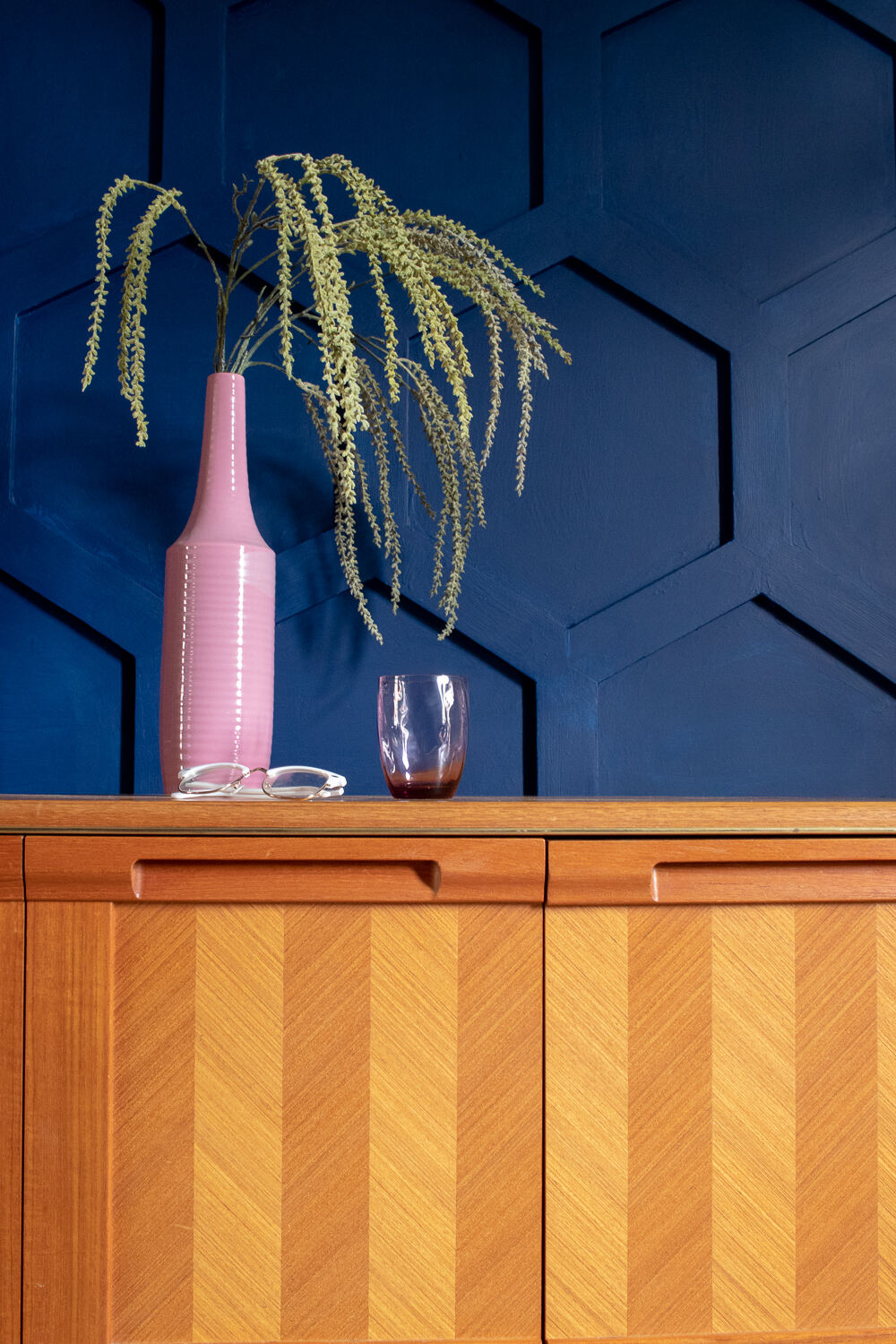 Hex wooden panelling has been fitted to this blue wall in a living room