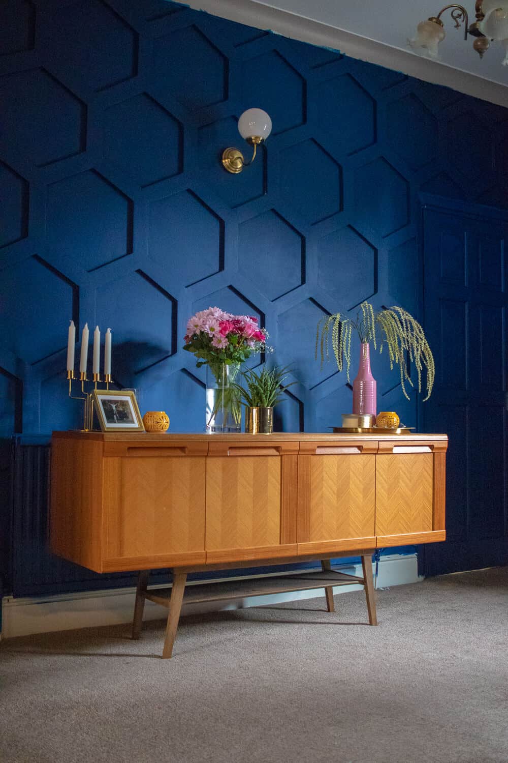 Hex wooden panelling has been fitted to this blue wall in a living room