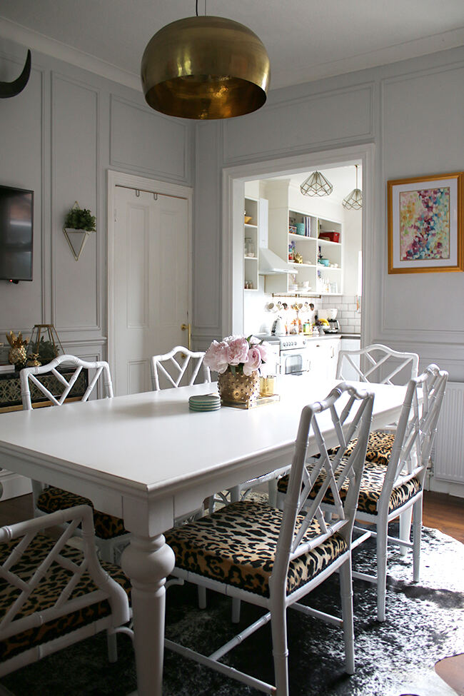 wooden panelling created by afixing moulding to the wall of this grey dining room