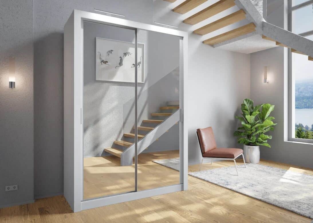 A white mirror sliding wardrobe in a minimalist scandi style home. A reflection of an open wooden staircase with glass balustrade is shown in the mirrored doors.