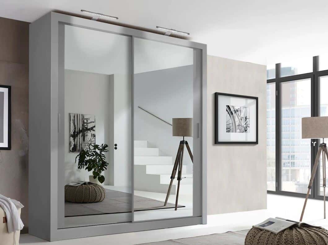 A white double wardrobe with mirrored sliding doors in a Scandi style room.