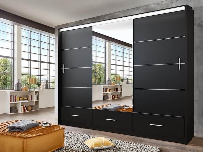 Triple mirror sliding wardrobe in black in an industrial style loft with black metal window frames