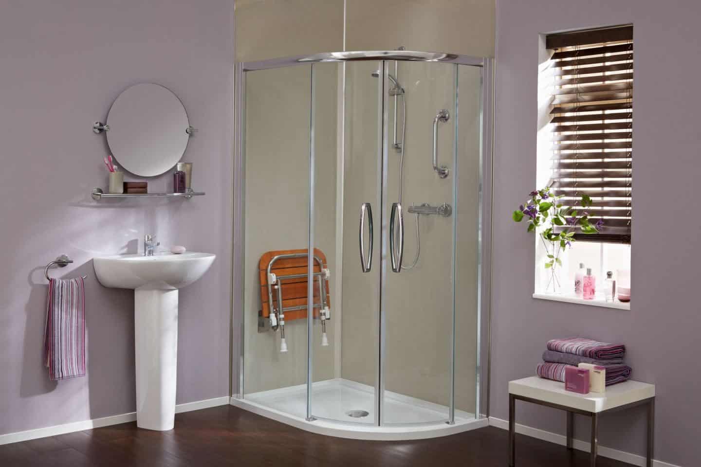 Accessible bathroom design from Premier Care Bathrooms. A walk-in shower feturing integrated shower seat and grab rails.