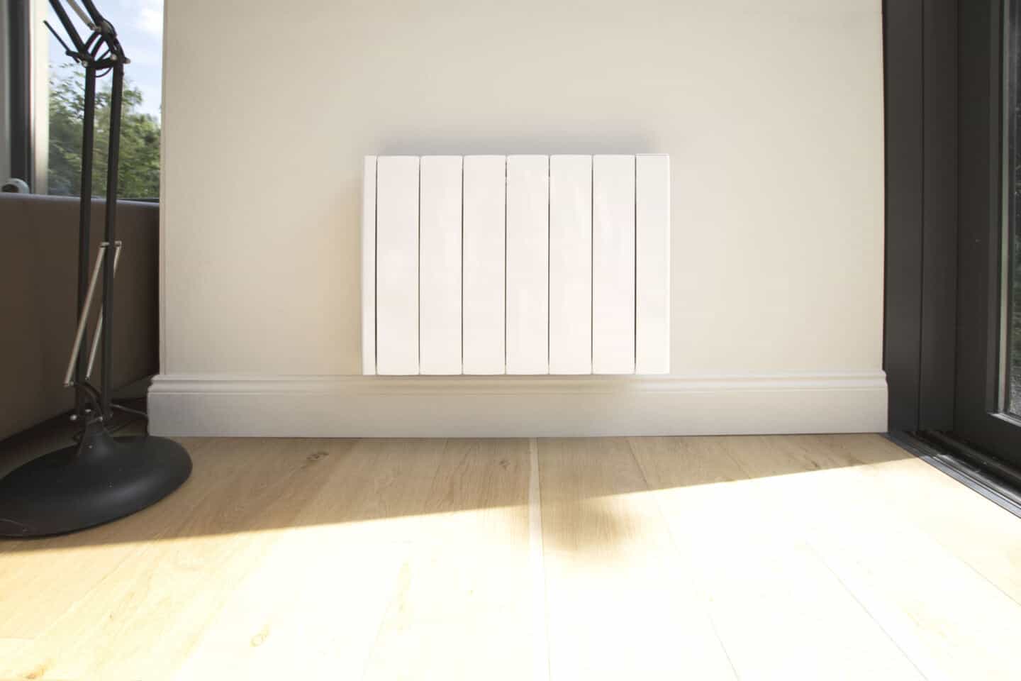 The Ecostrad iQ Ceramic smart electric radiator mounted on a white wall