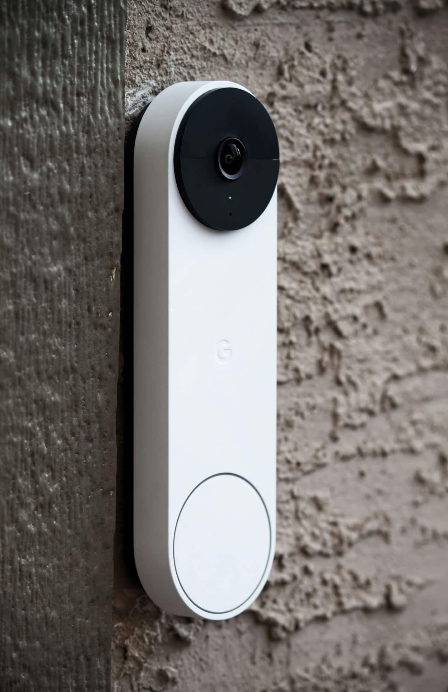 A close up of a smart video doorbell on a wall for added home security