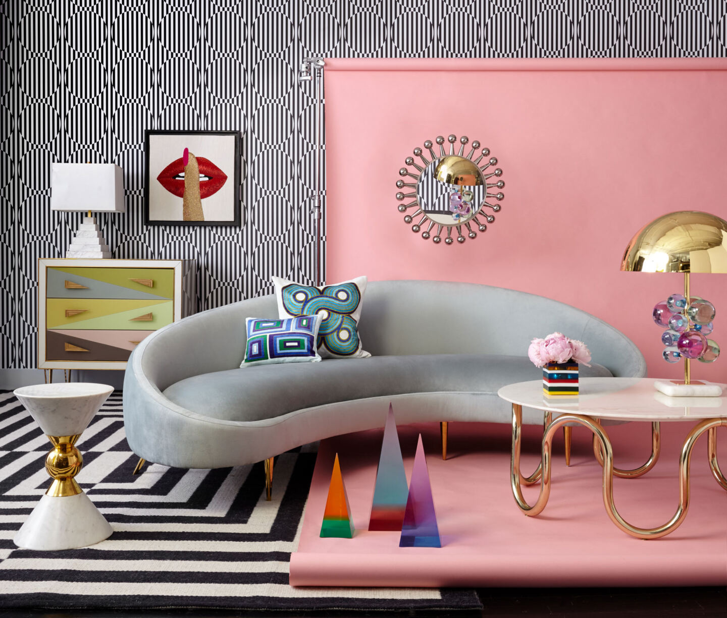 Curved furniture with a pink wall and geometric background.