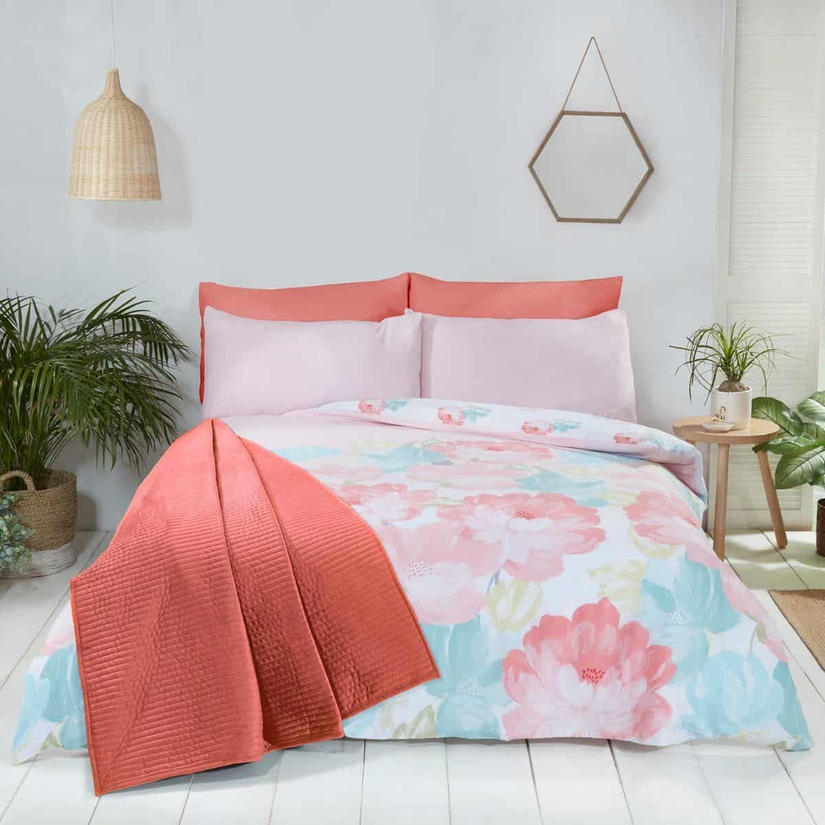 A coral and blue floral bedroom in soft tones will help to promote good quality sleep