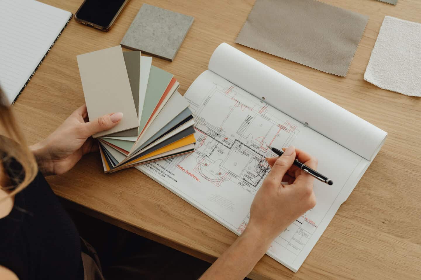 A woman looking at floor plans for a home renovation project