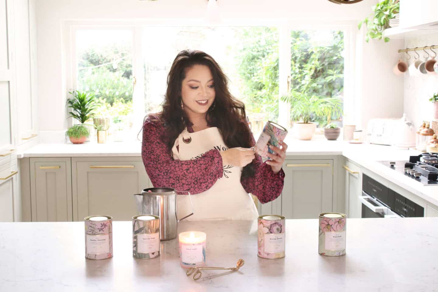 Kimberly Duran of Swoon Worthy Scents in her kitchen with her signature collection of luxury eco-conscious scented candles