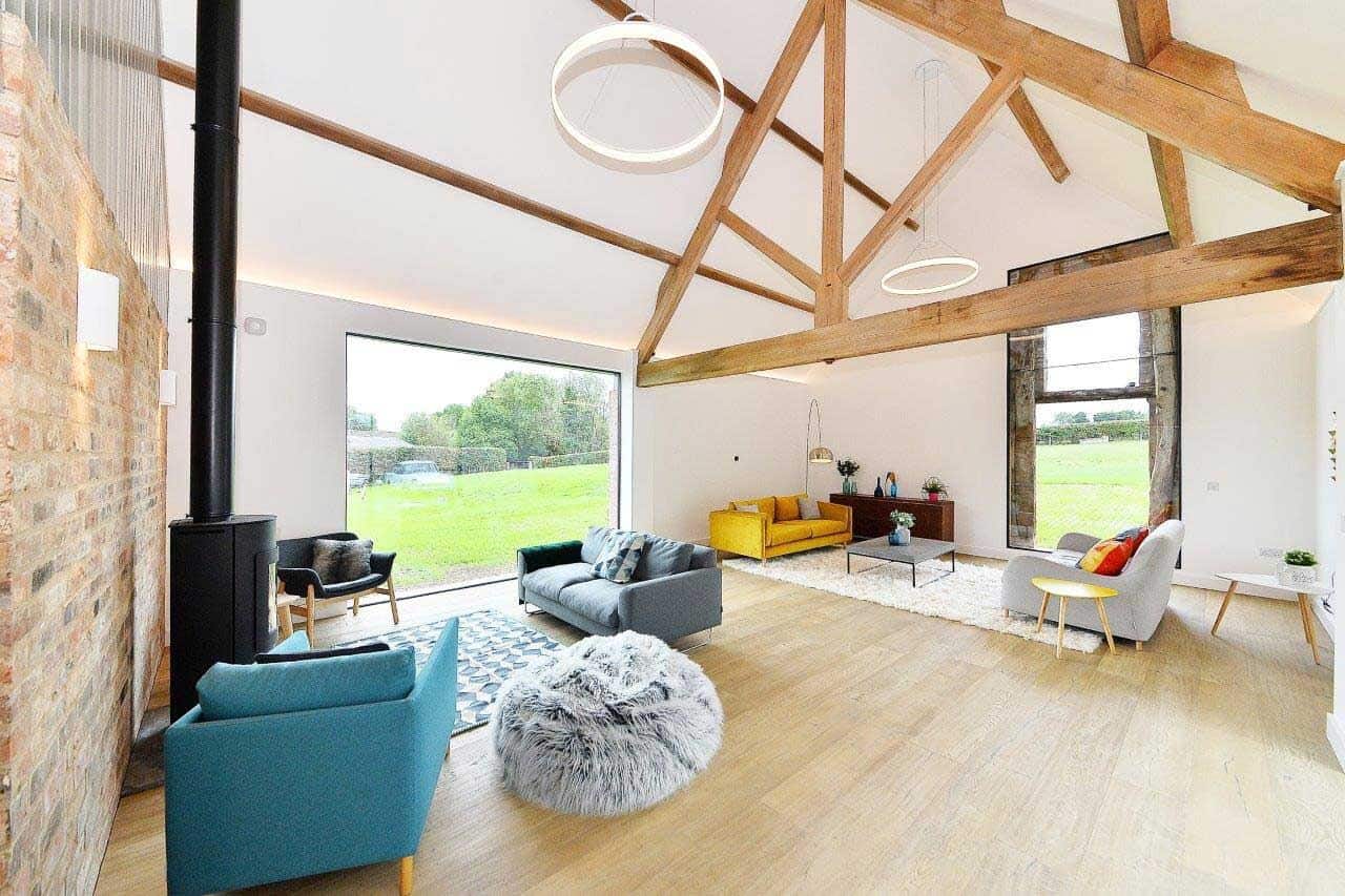 A modern Scandi style home with roof timbers and large aluminium windows maximises natural light