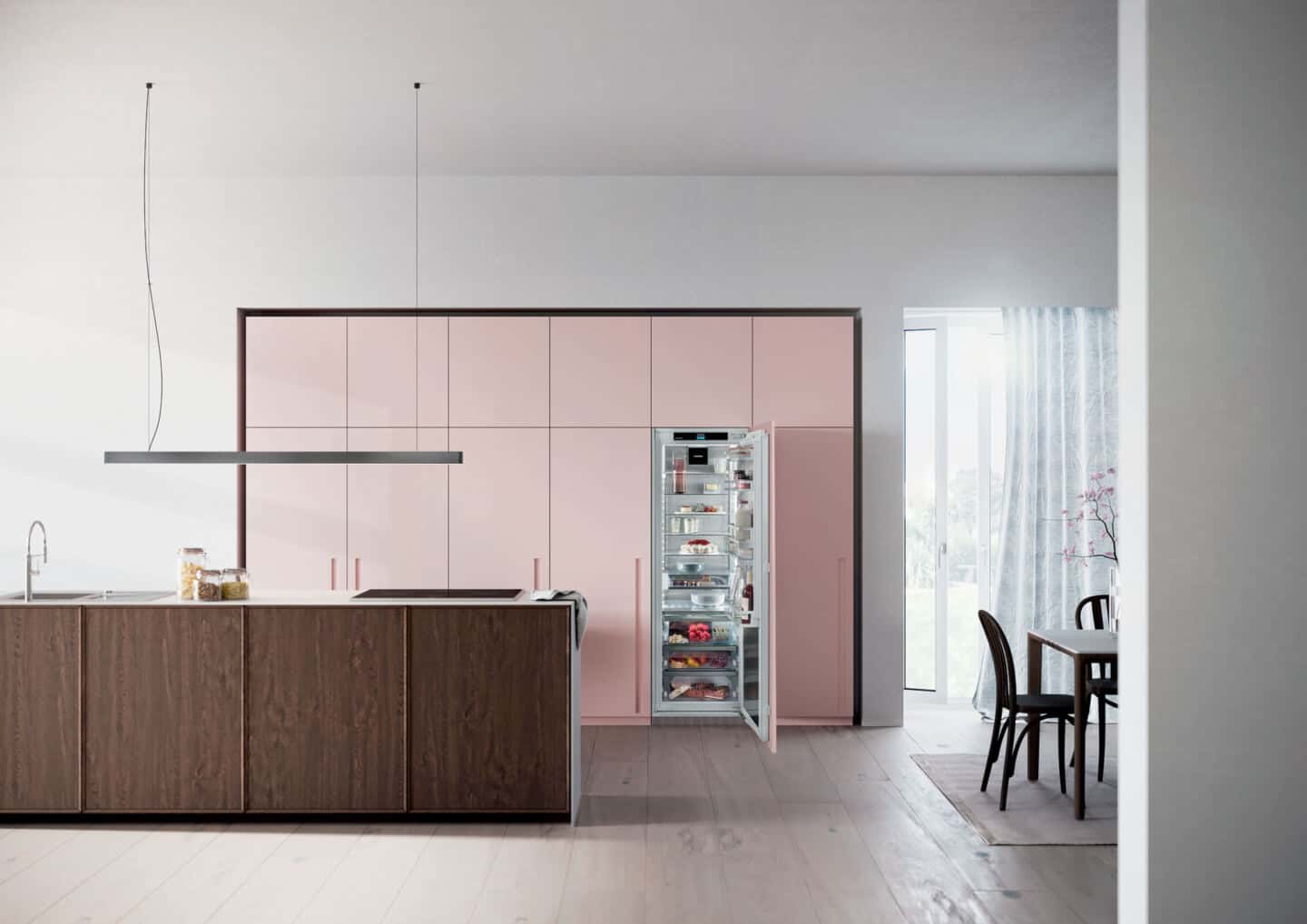 Liebherr's Fully Integrated Appliance Range. An open fridge in a pink kitchen