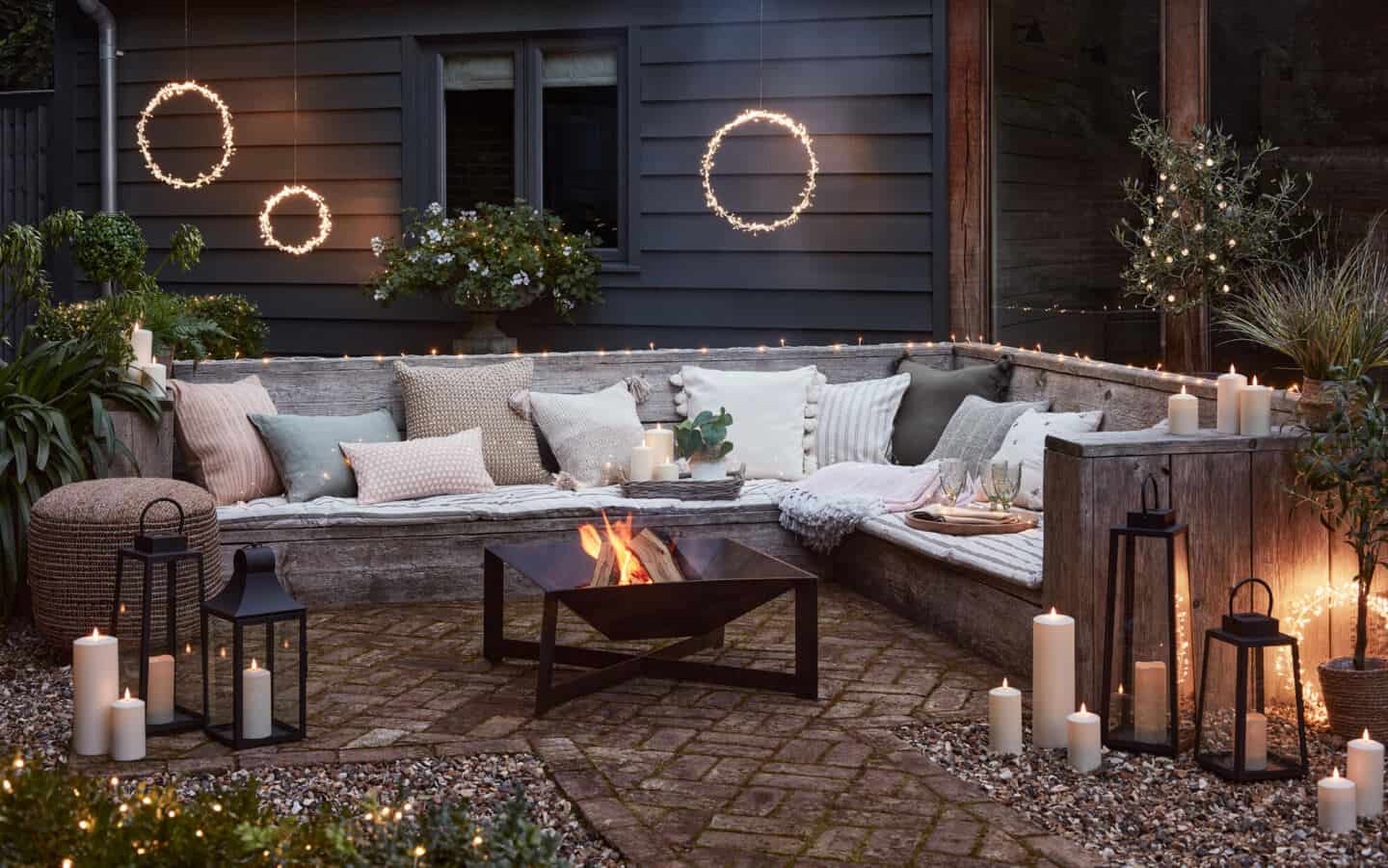 Outdoor Space with seating, Hanging Lights, Lanterns, Candles and a Firepit