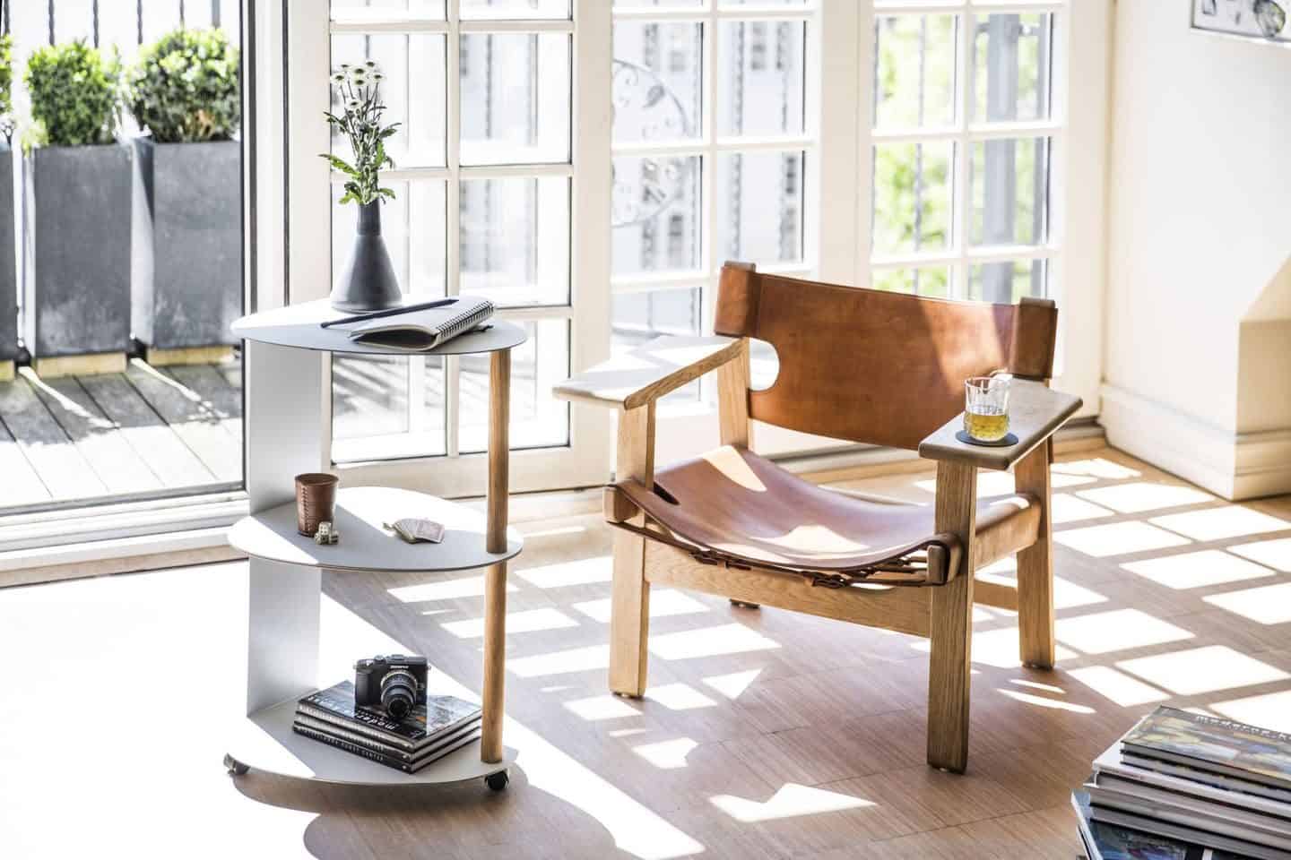 Recycled leather chair and LIND DNA 3-tier side table in front of French doors