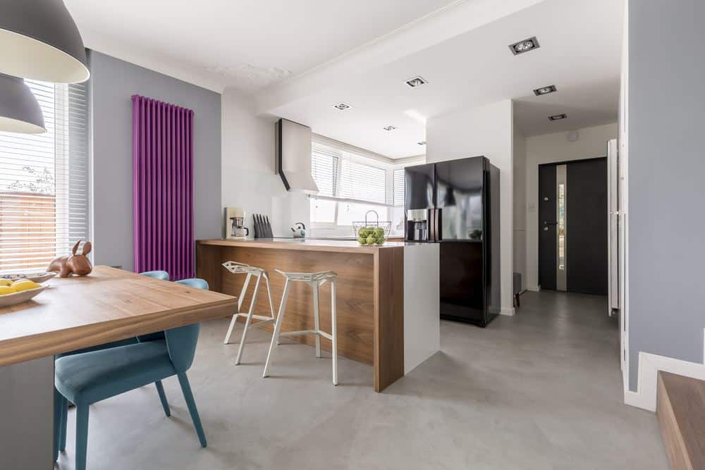 Radiator buying guide - modern kitchen diner featuring a vertical purple column radiator