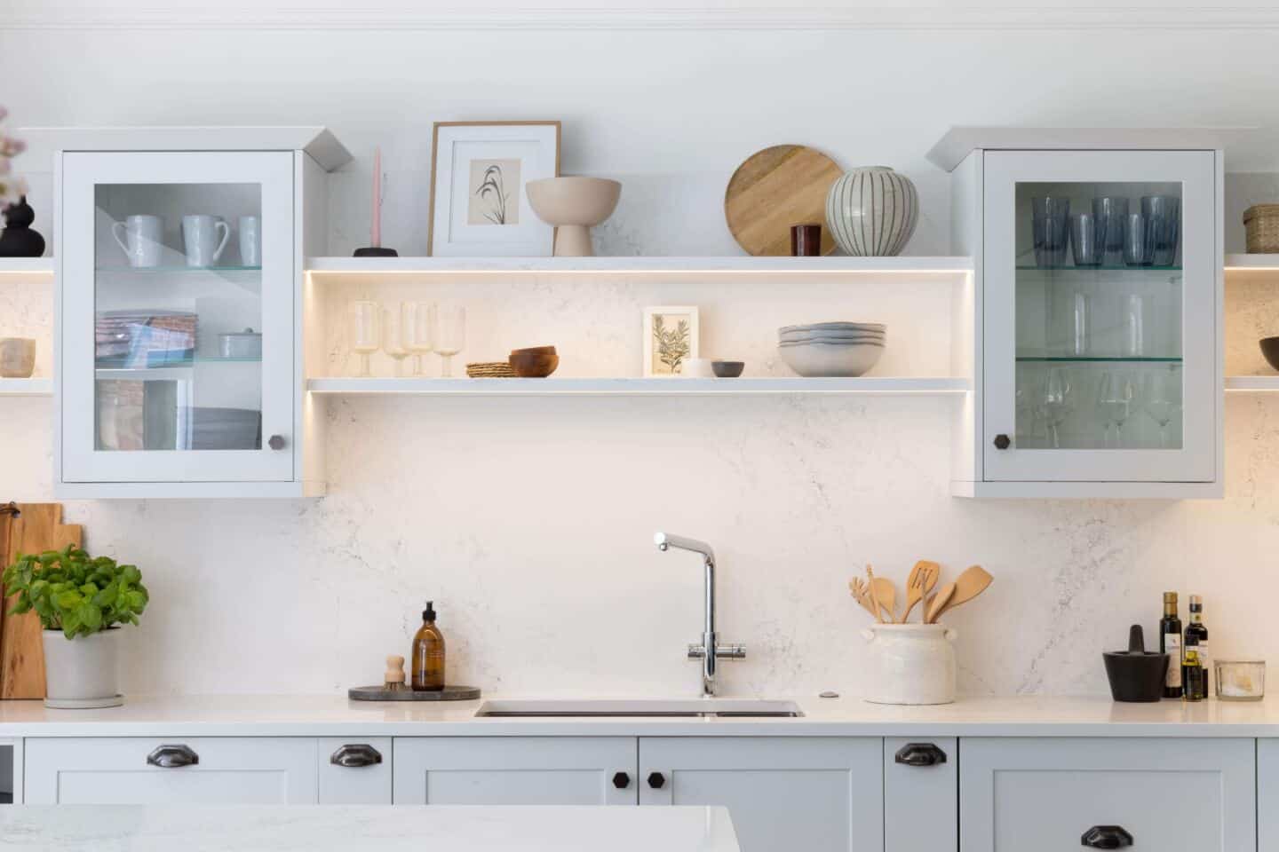 Minimalist kitchen design featuring open shelving to display carefully curated ceramics and kitchen accessories