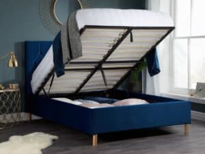 An open blue ottoman bed in a bedroom