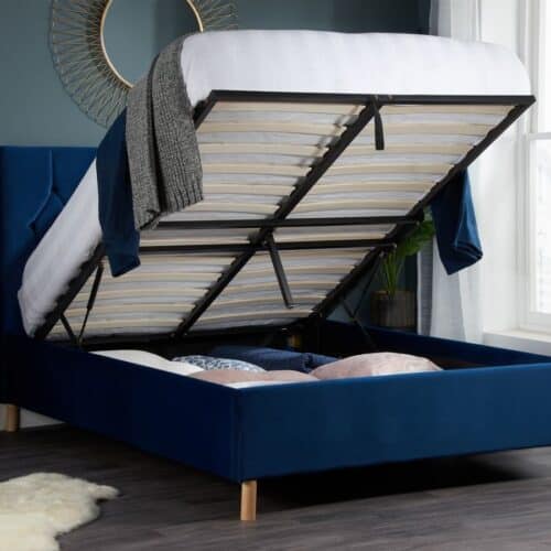 An open blue ottoman bed in a bedroom