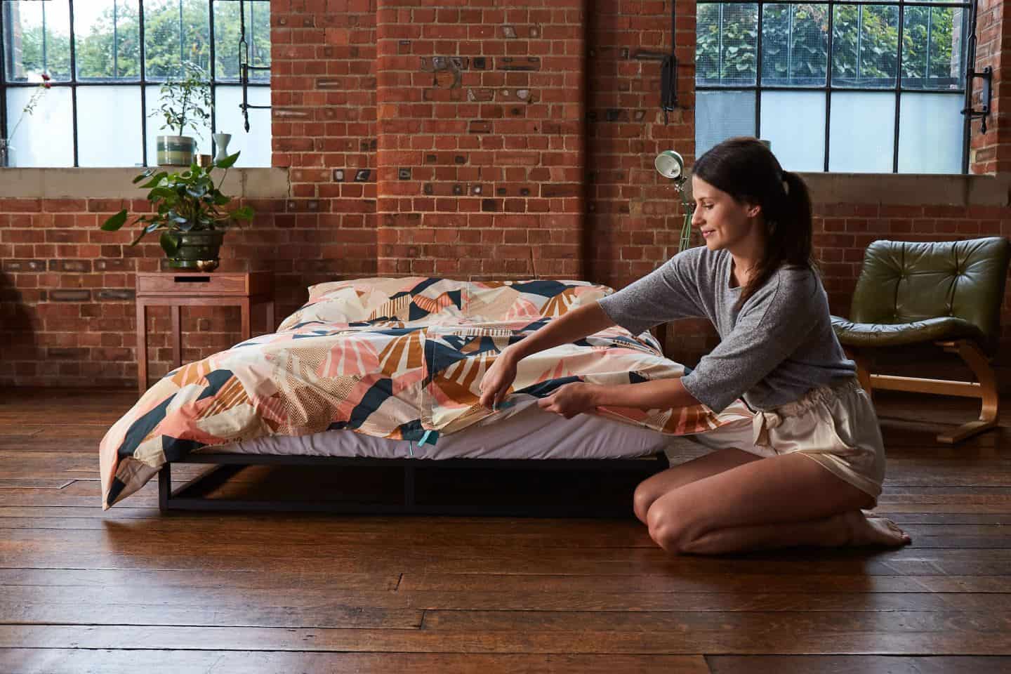 Koa revolutionary duvet cover. A women zips up the base of the duvet cover. The easy way to change a duvet cover