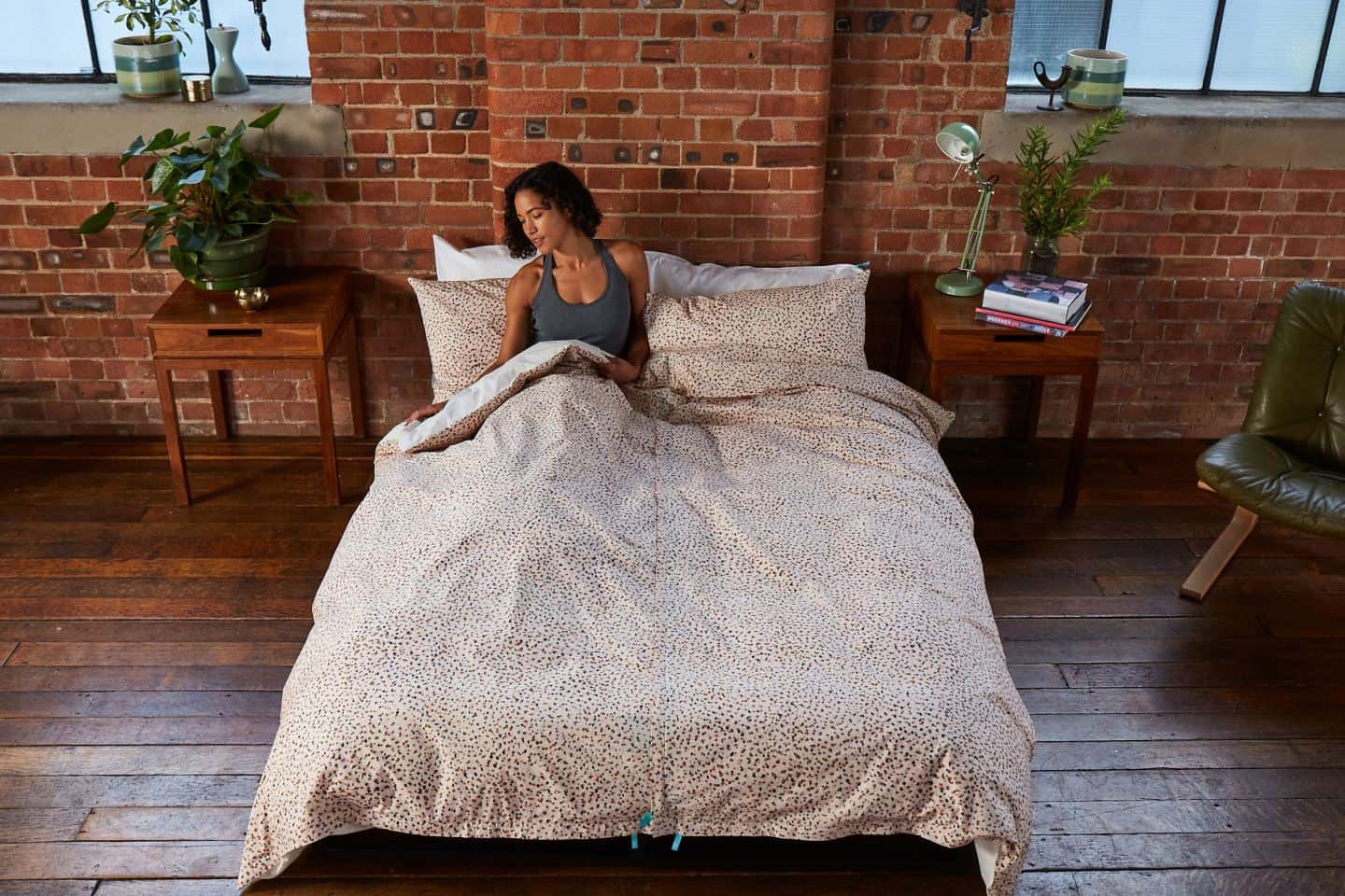 Koa revolutionary duvet cover. A woman in bed in an industrial style loft bedroom. The easy way to change a duvet cover