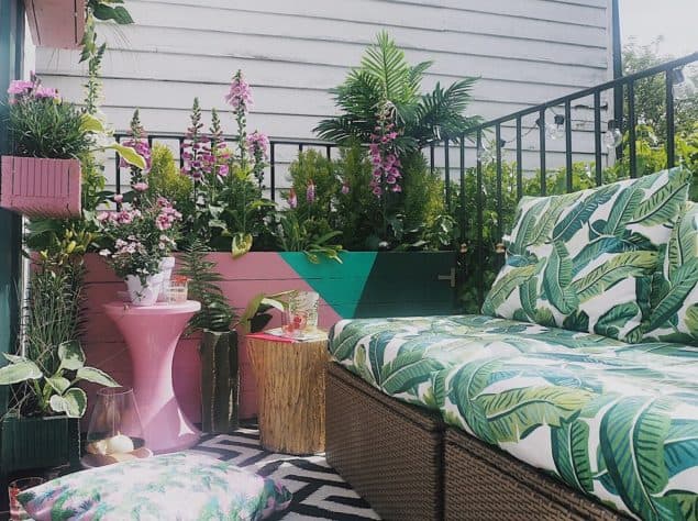 Melanie Lissack Interiors Garden Balcony Makeover featuring botanical upholstery, painted planers and outdoor stools