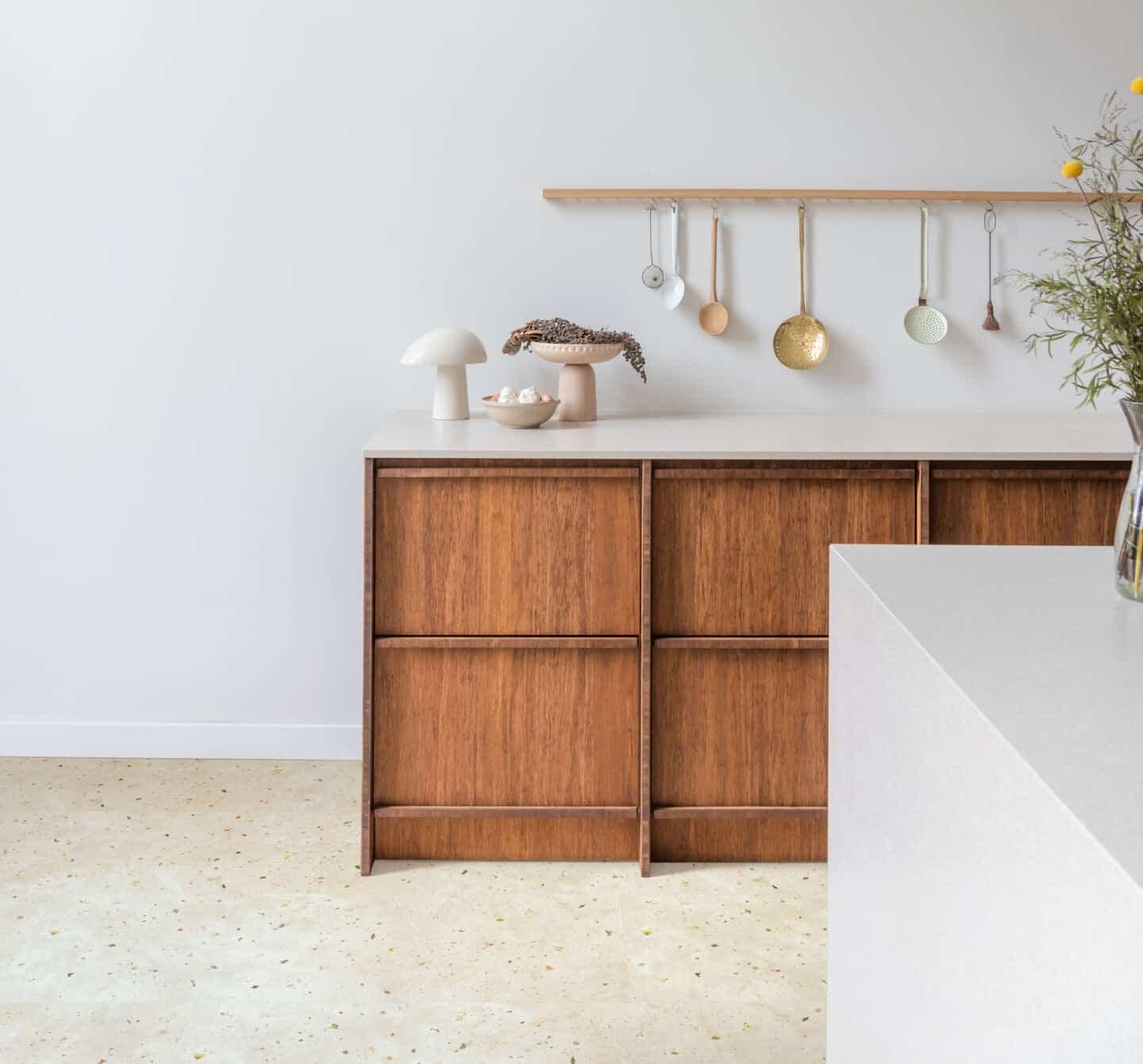 A minimalist wooden kitchen with a nature-inspired laminate flooring. Flooring is Botanic Concrete from Quickstep