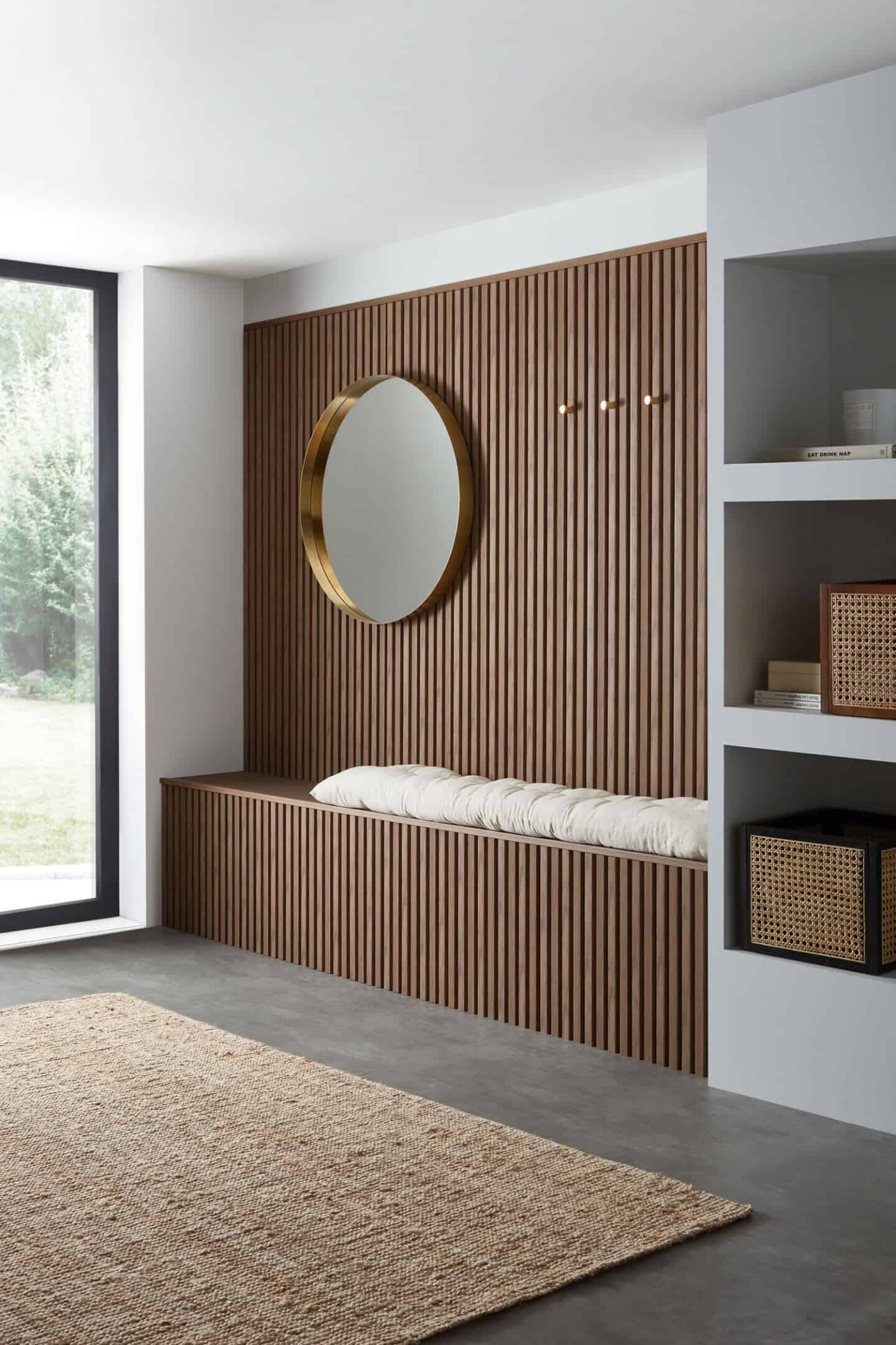 A minimalist hallway with wooden slat wall and built-in bench seat