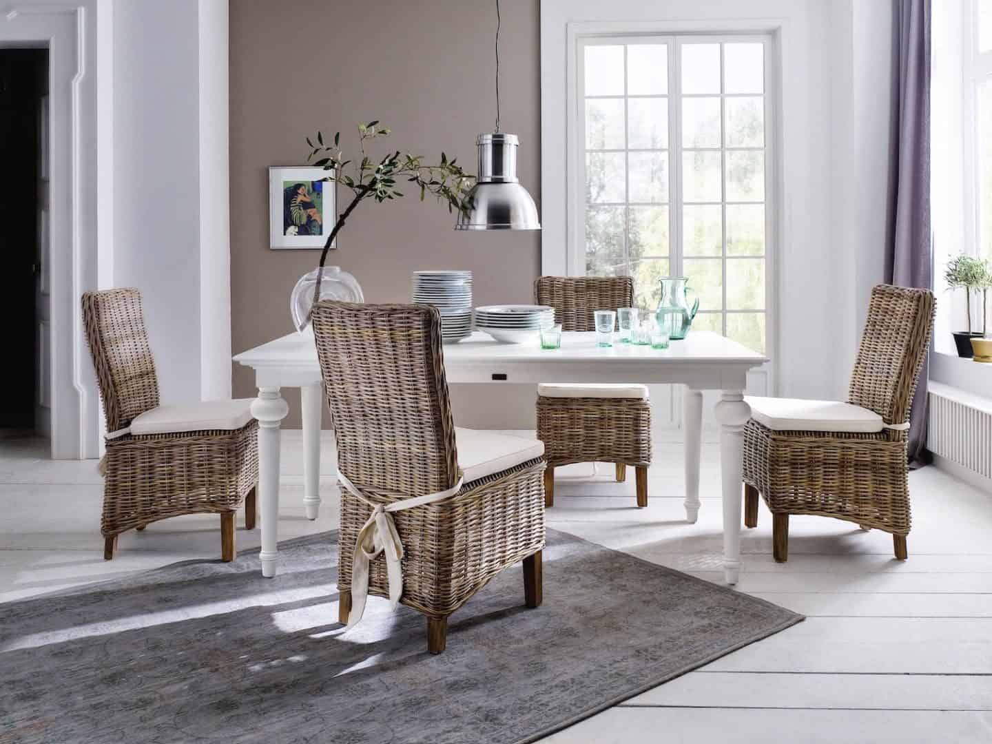 New Nordic interior featuring white floor boards, rattan furniture  and neutral walls. Furniture from the Provence range from Novasolo