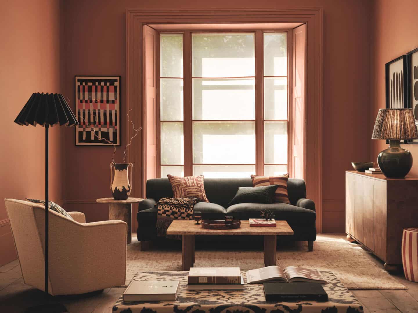 A living room decorated in autumnal colours featuring furniture in natural materials