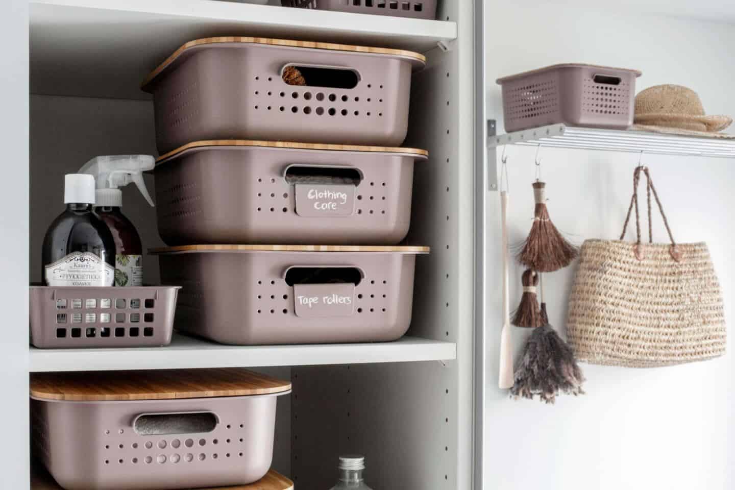 Labelled storage boxes staked up on shelves in a laundry room