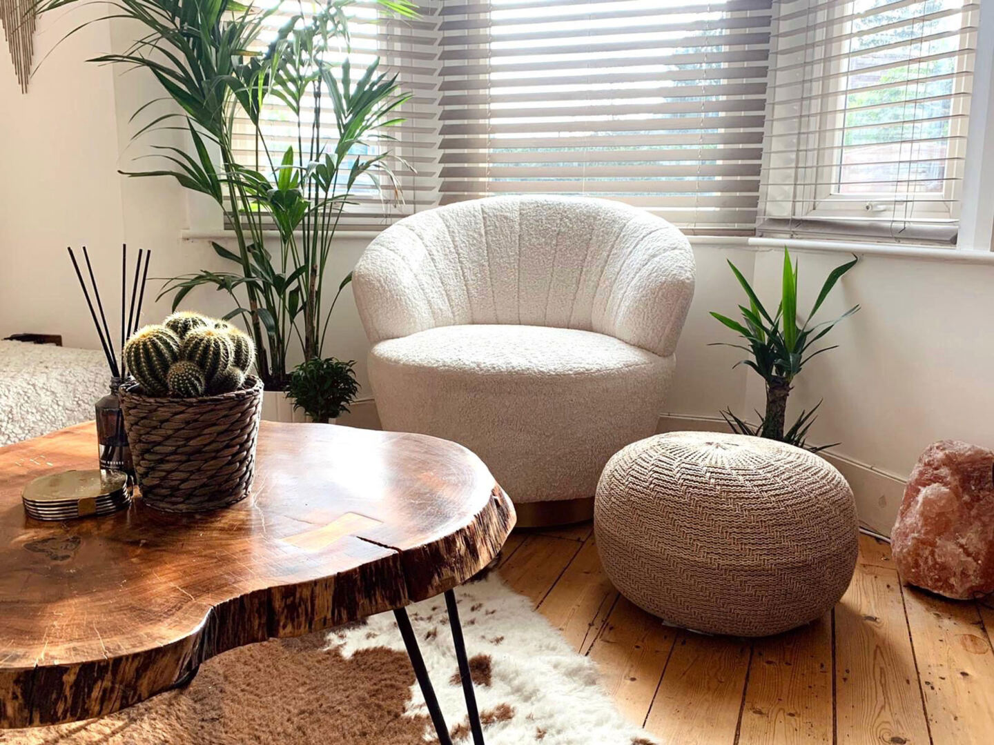 curved chair with curved wooden table and pouffe.