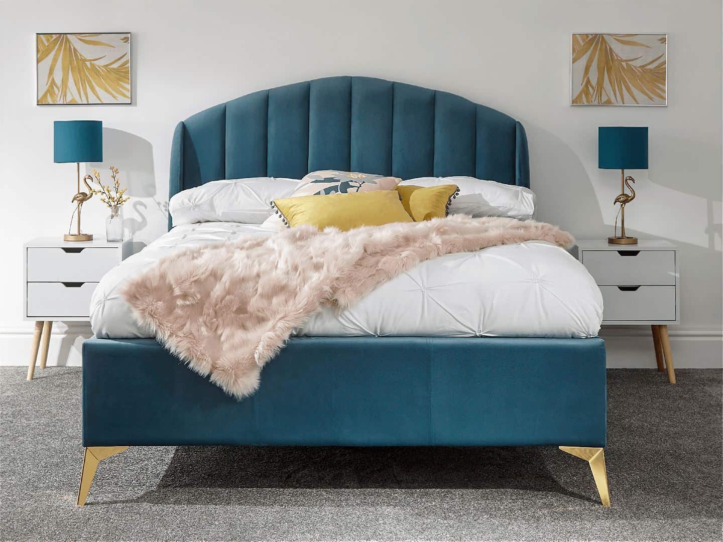 A white bedroom featuring a teal ottoman bed with brass legs. The storage is closed and you cannot tell it is an ottoman bed