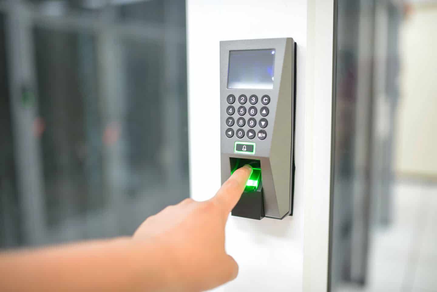 Someone putting a finger into a  biometric home security device