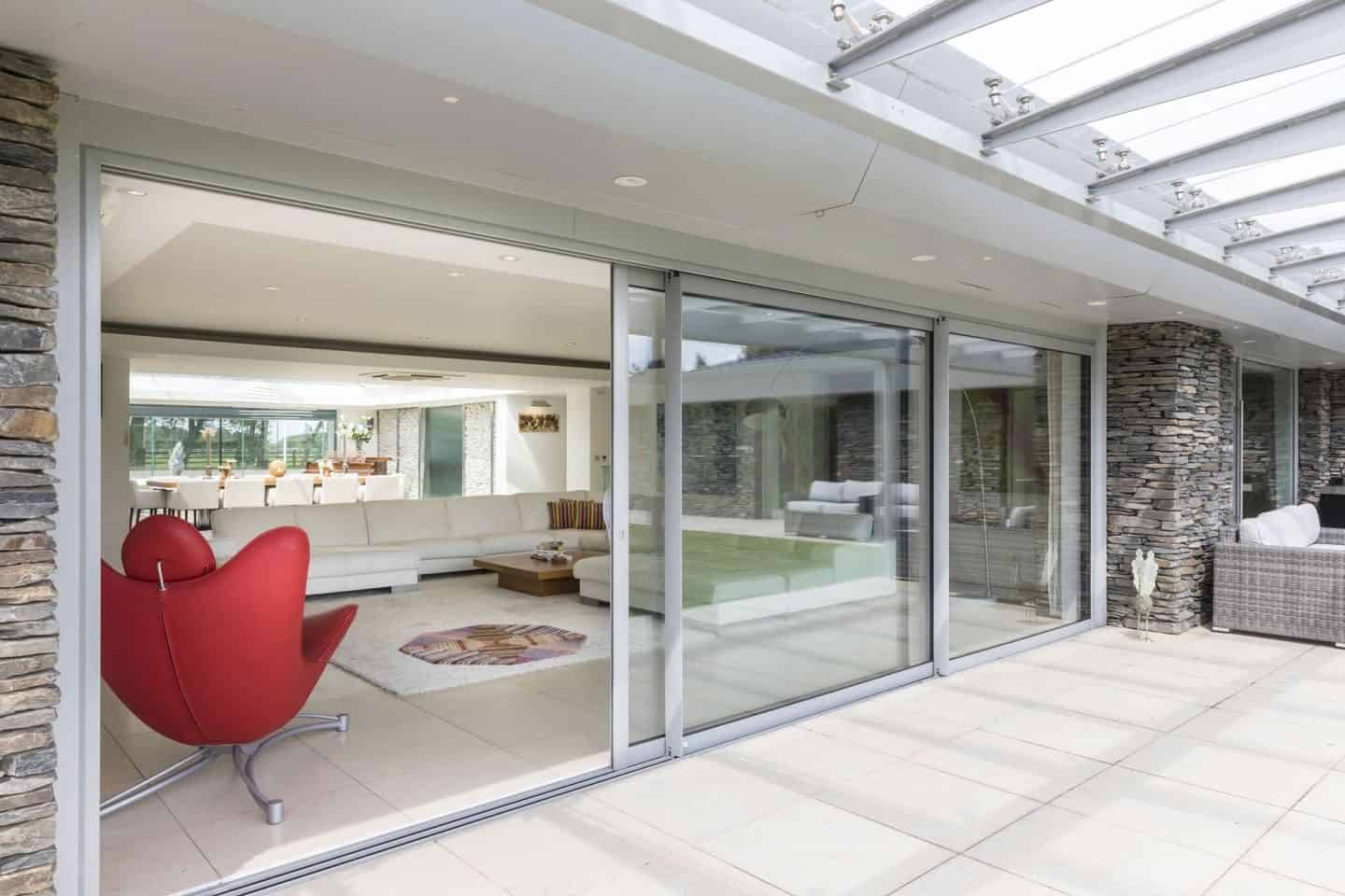 Pilkington Glass large glazed sliding doors from living room leading out onto a garden patio