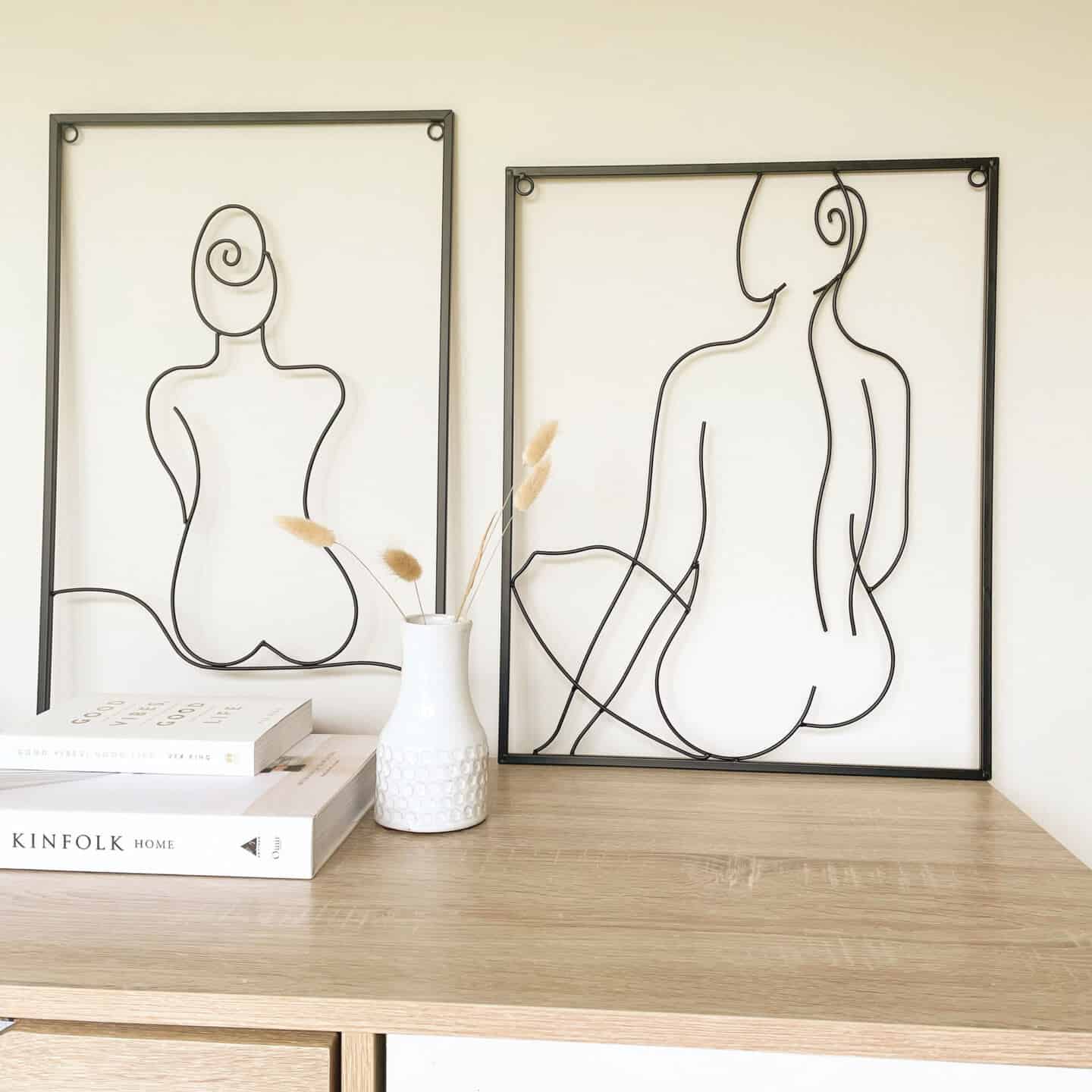 Affordable luxury homewares from Price & Coco Interiors. Two pieces of wire artwork on a sideboard leaning against the wall.