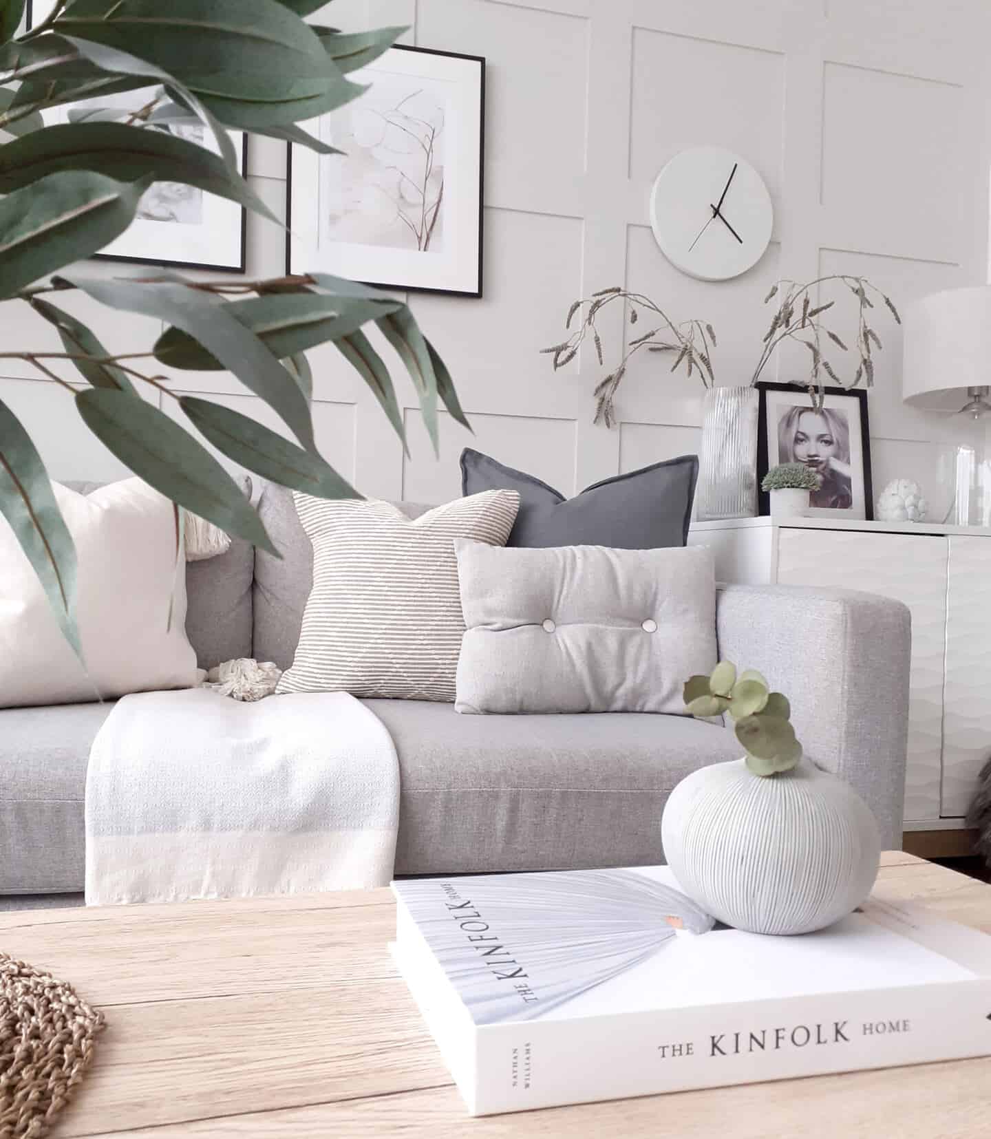 Affordable luxury homewares from Price & Coco Interiors. A small textured vase on a book on a coffee table in a monochrome Scandi living room.