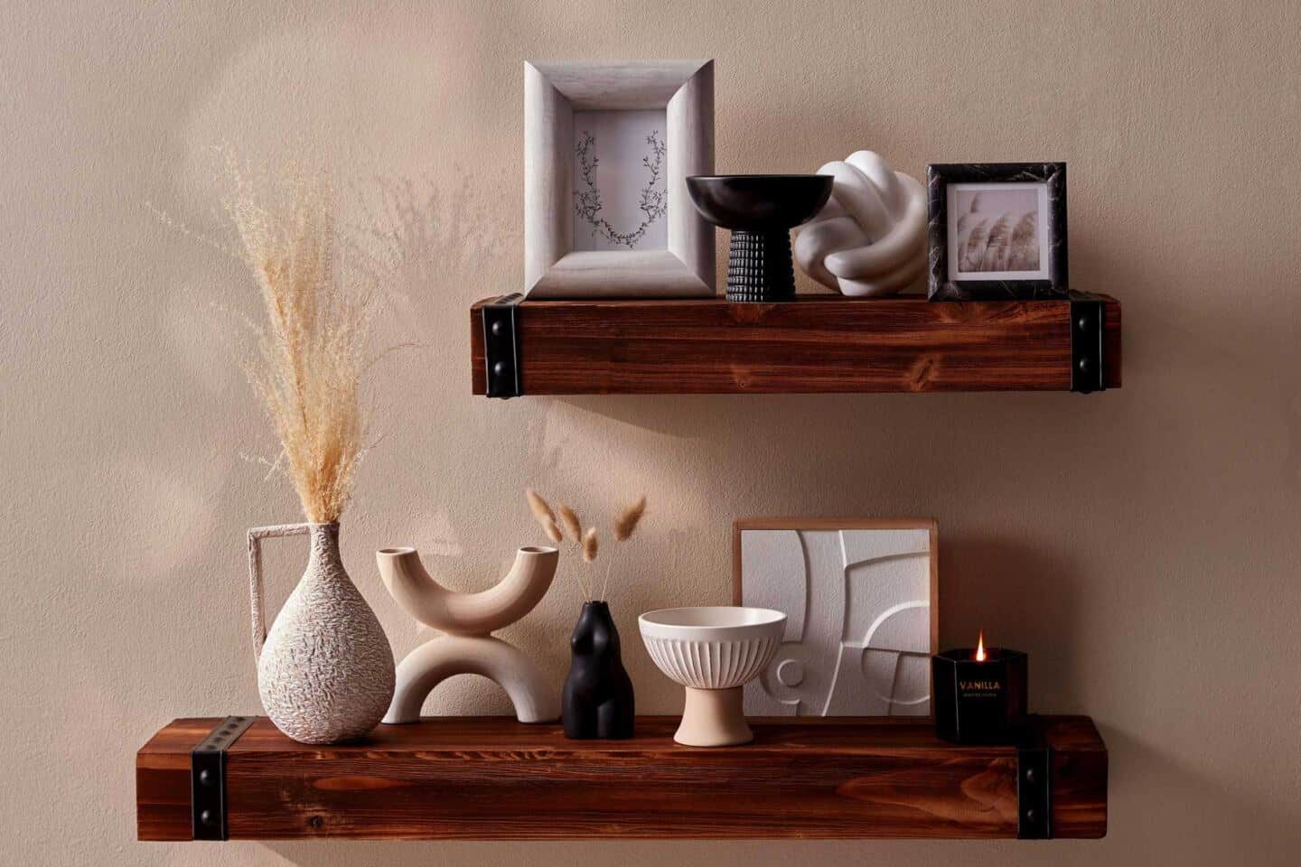 A selection of Primark Homeware pieces from the SS22 range arranged on two chunky wooden wall shelves 