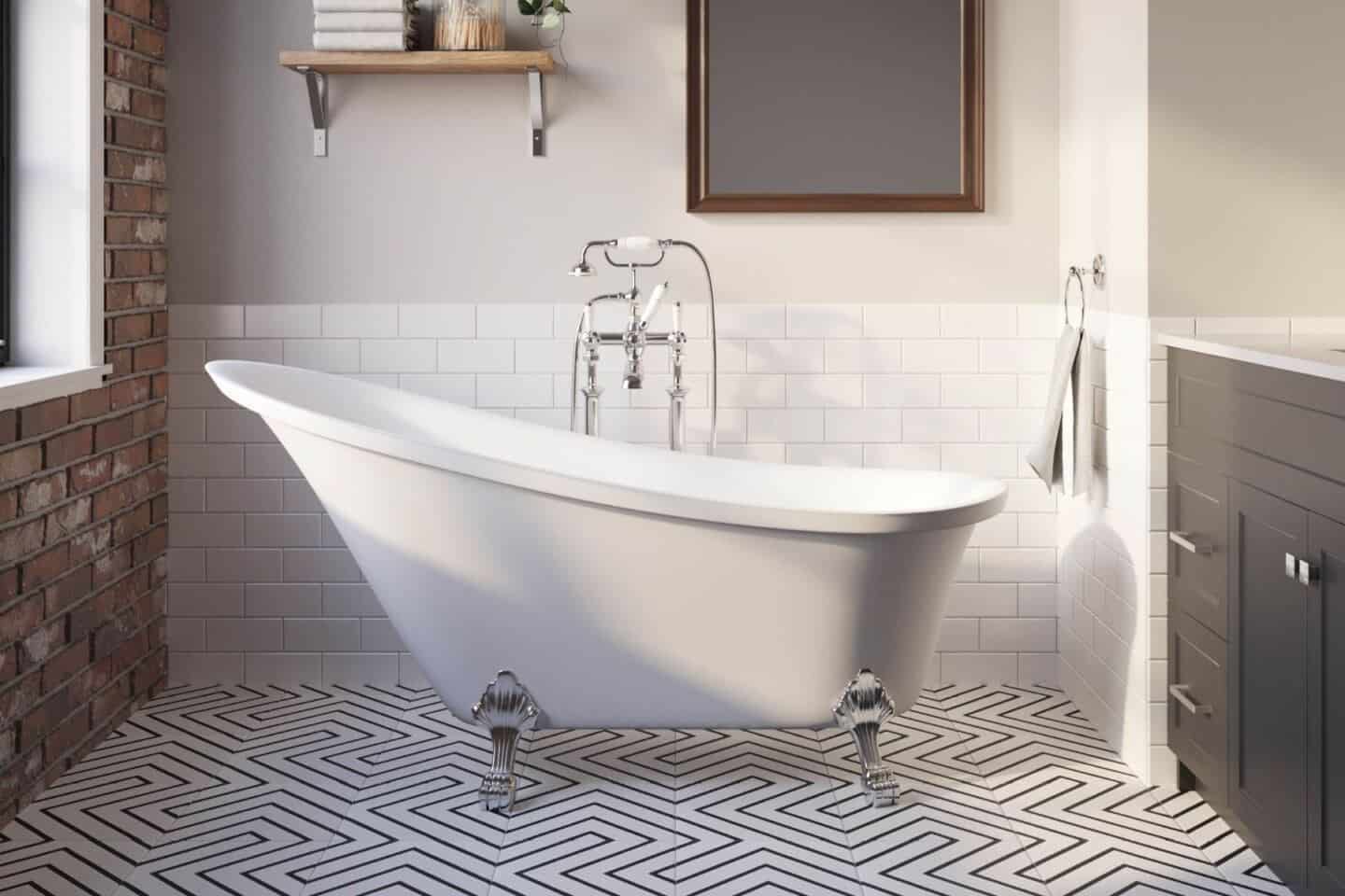 Arielbath freestanding slipper bath on patterned tile floor with dark vanity unit to the side