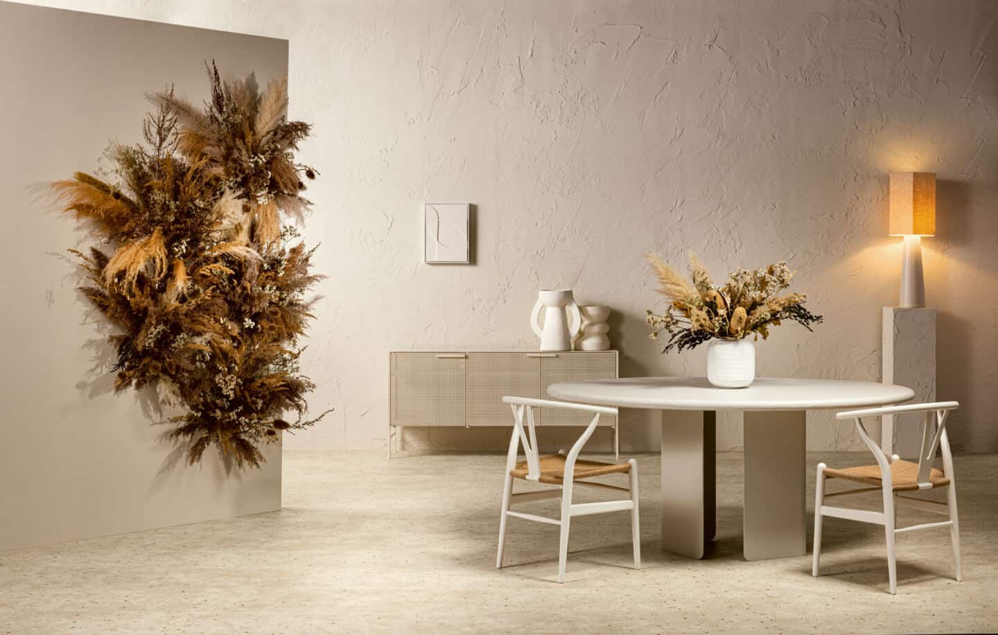 A minimal japandi style dining room with rough textured walls and botanic concrete flooring