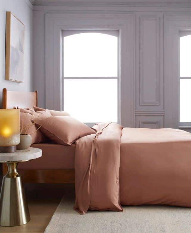 pink bamboo bedding on a wooden bed