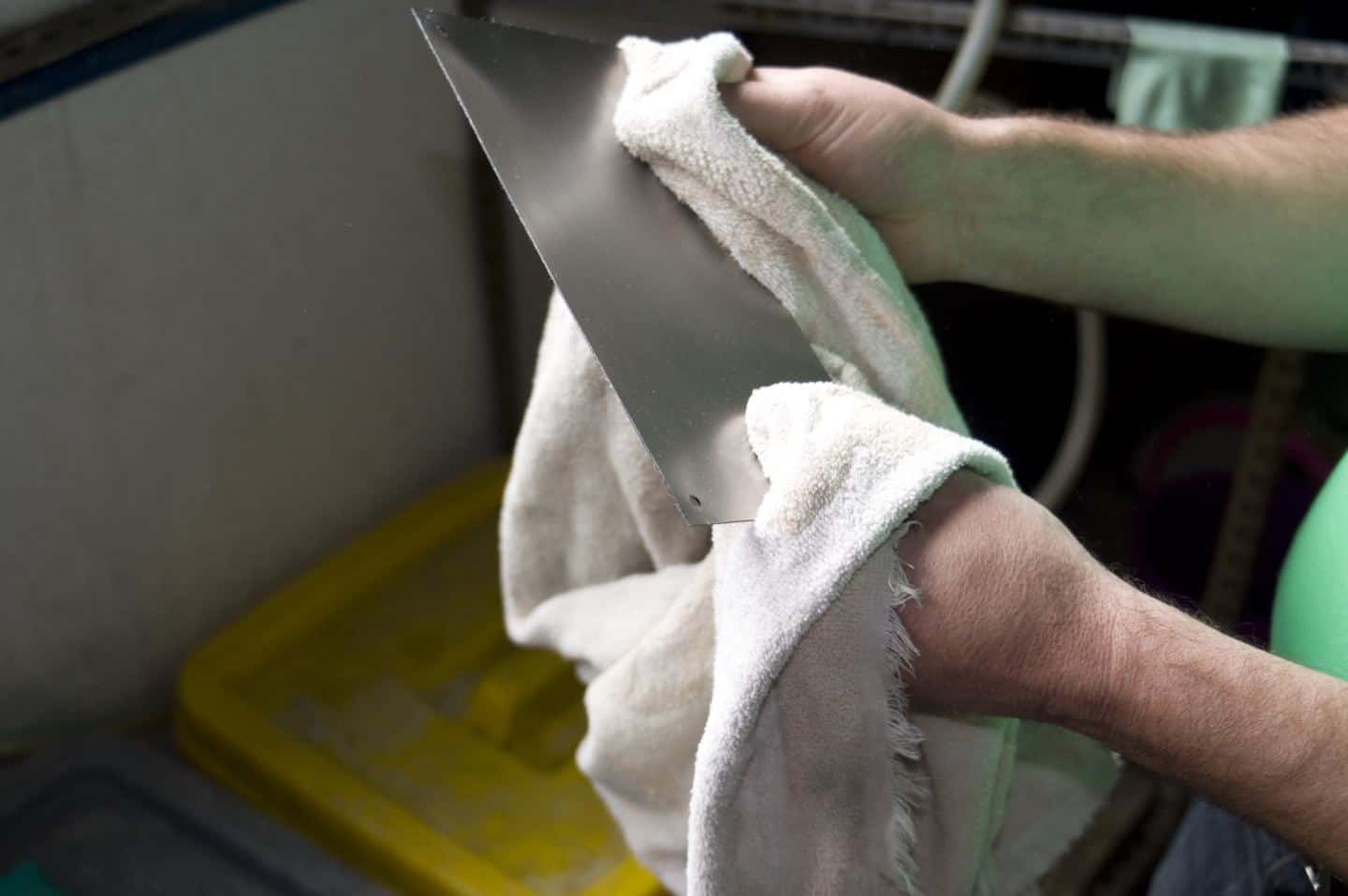 Production of enamel signs for homes and businesses at Ramsign. Polishing the metal plate